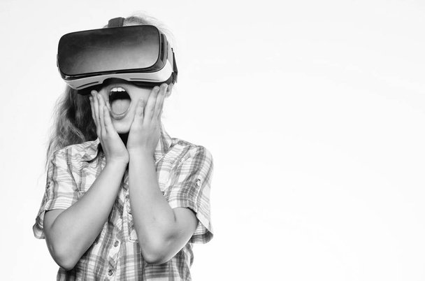 Small kid use modern technology virtual reality. Virtual education for school pupil. Get virtual experience. Virtual reality concept. Girl cute child with head mounted display on white background - Photo, Image