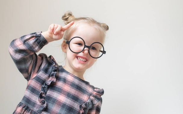 Caucasian little girl with round glasses. Little teacher. Funny glasses humor. Retro style - Fotoğraf, Görsel