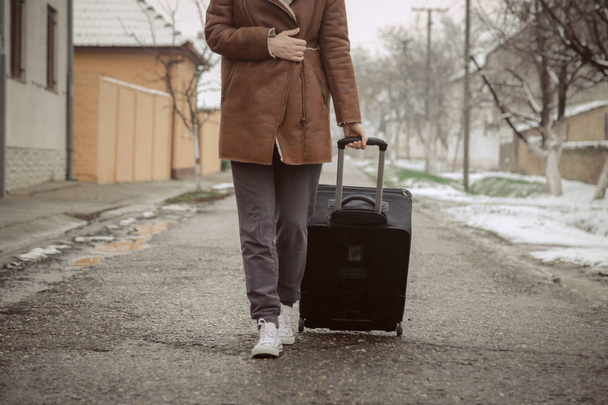 Young woman with suitcase on the street - Fotografie, Obrázek