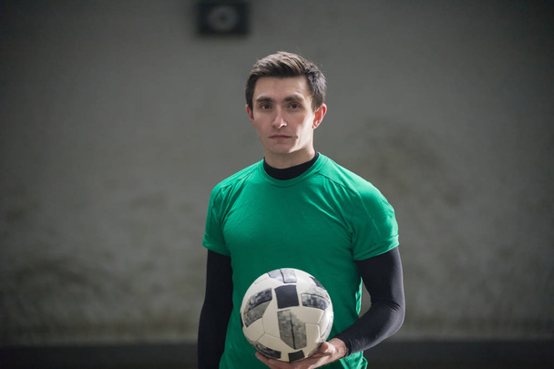 Football concept. Soccer player holding a ball - Photo, Image
