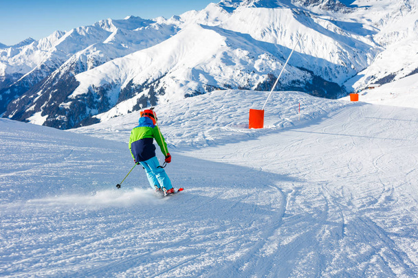 Cute skier boy in a winter ski resort. - Foto, Bild