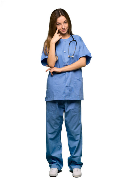 Full body Young nurse looking to the front on isolated background - Fotografie, Obrázek