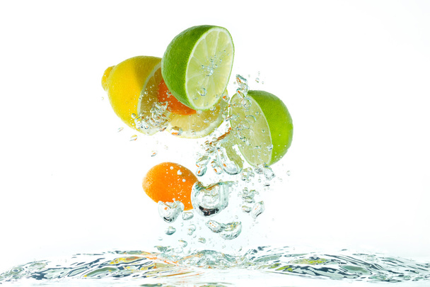 Citrus fruit jumping out of the water - Photo, Image