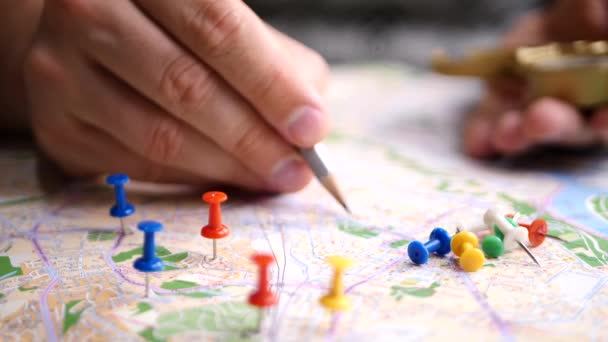 Men planning hiking trip on a map - Footage, Video