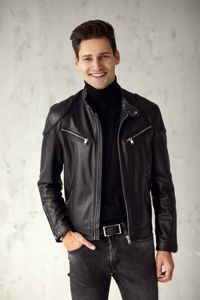 Handsome man in black outfit smiling - Фото, изображение