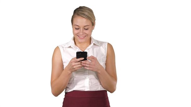 Business lady texting message while walking on white background. - Foto, imagen