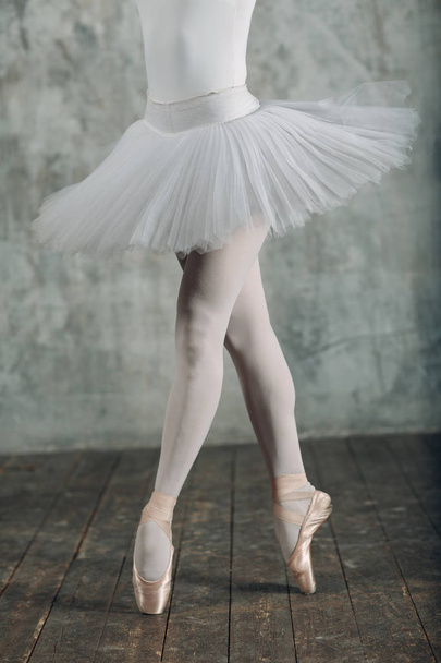 Ballerina female. Young beautiful woman ballet dancer, dressed in professional outfit, pointe shoes and white tutu. - Zdjęcie, obraz