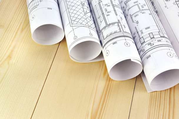 Photo of several drawings for the project engineer jobs and wooden boards - Foto, imagen