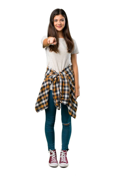 A full-length shot of a Teenager girl with shirt tied to the waist points finger at you with a confident expression - Foto, imagen