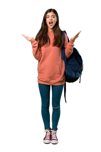 A full-length shot of a Teenager girl with sweatshirt and backpack with surprise and shocked facial expression - Photo, Image