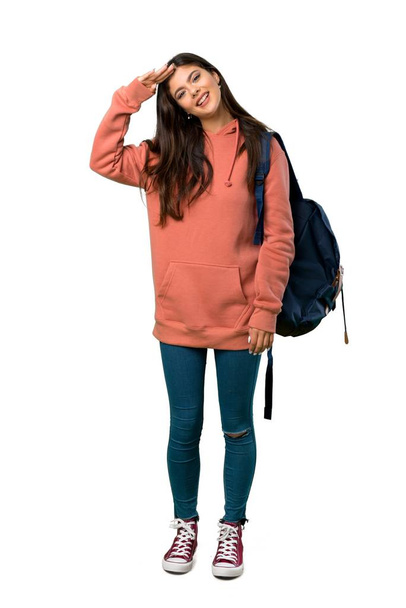 Un plan complet d'une adolescente avec sweat-shirt et sac à dos saluant à la main
 - Photo, image
