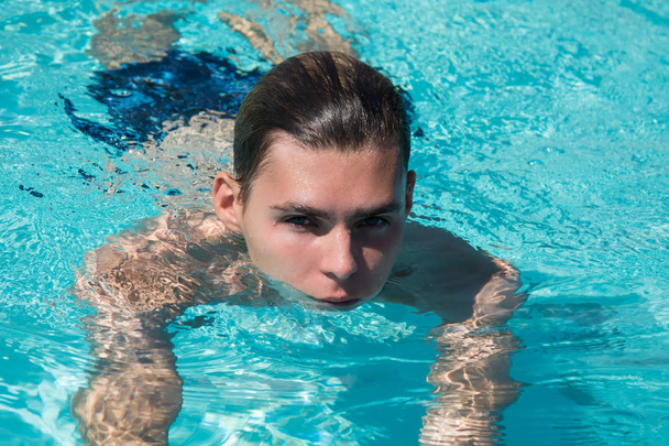 Young attractive guy. Summer, relaxation and pool. - Foto, Imagen