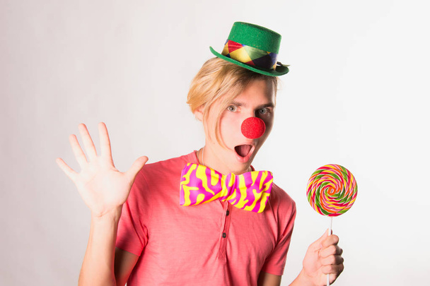 Young funny clown and candy. - Photo, Image