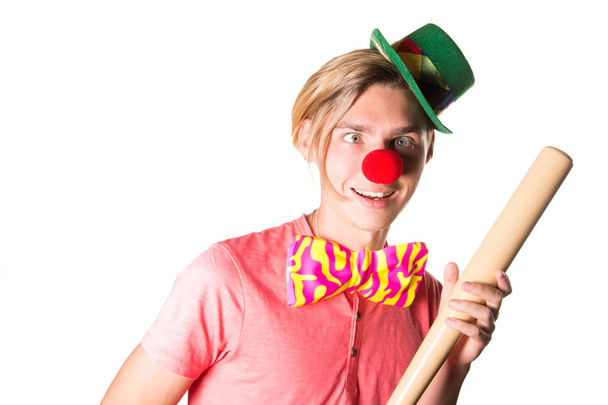 Young funny clown and baseball bat.Mad smile. - Photo, Image