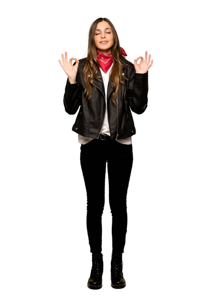 Full-length shot of Young woman with leather jacket in zen pose on isolated white background - Photo, Image