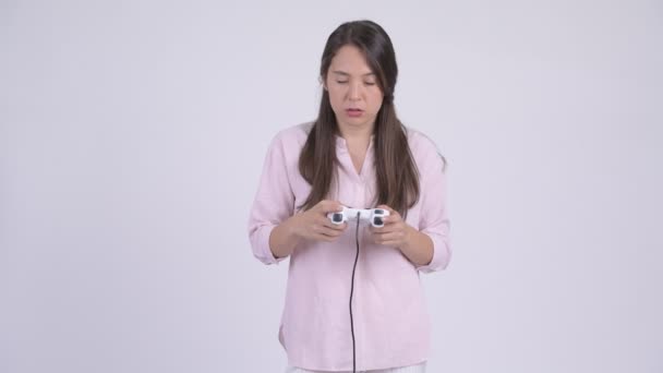 Young tired multi-ethnic businesswoman playing games and falling asleep - Footage, Video