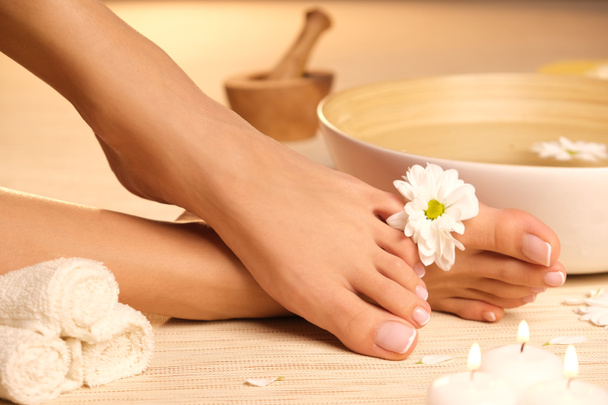 The picture of ideal done manicure and pedicure. Female hands and legs in the spa spot. - Zdjęcie, obraz