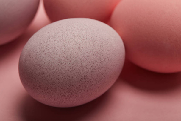 Selective focus of painted easter eggs on pink background  - Fotografie, Obrázek