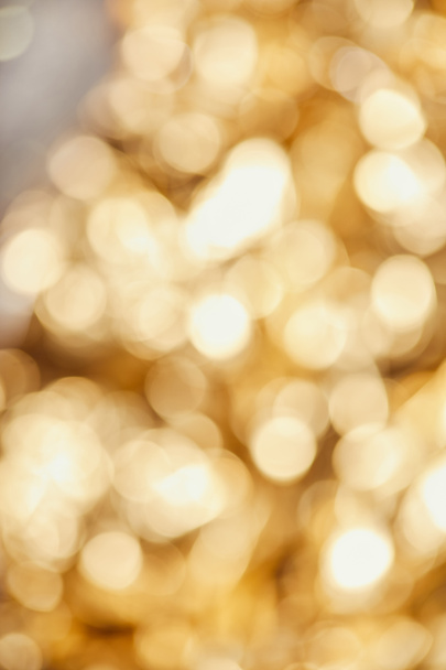 bright blurred golden twinkles and sparkles on grey background - Photo, image