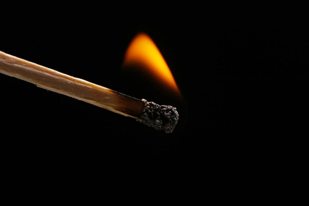 An igniting match against black background - Photo, Image