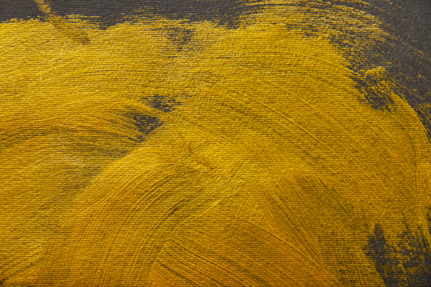 different brushstrokes of golden paint on grey background - Фото, зображення