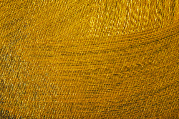 dark canvas drawn of different golden brushstrokes - Fotografie, Obrázek