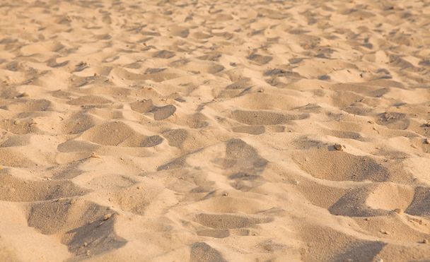 Closeup of sand pattern of a beach in the summer. Background.concept for summer season - Fotoğraf, Görsel