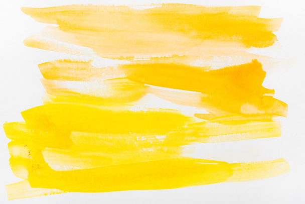 top view of yellow watercolor brushstrokes on white background - Photo, Image