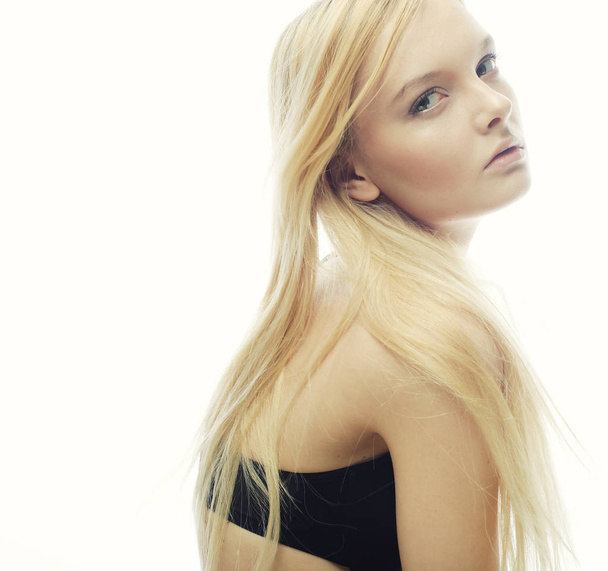 woman with long blond hair. Fashion model posing at studio. - Fotó, kép