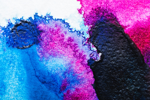 top view of blue, black and pink watercolor spills on white paper - Φωτογραφία, εικόνα