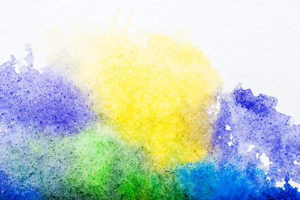 top view of blue, yellow, purple and green watercolor spills on white background  - Fotoğraf, Görsel