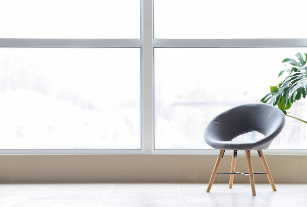 Stylish chair near big window in room - Photo, Image