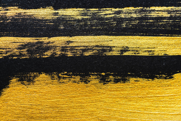 top view of yellow watercolor brushstrokes on black background with copy space  - Foto, Imagen