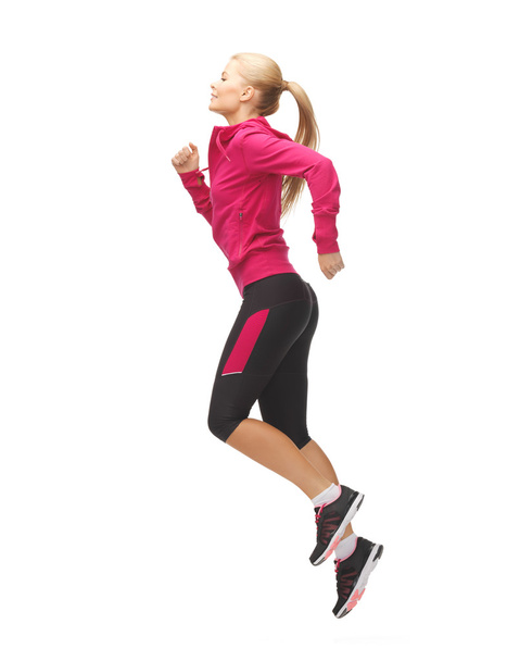 Sporty woman running or jumping - Fotó, kép