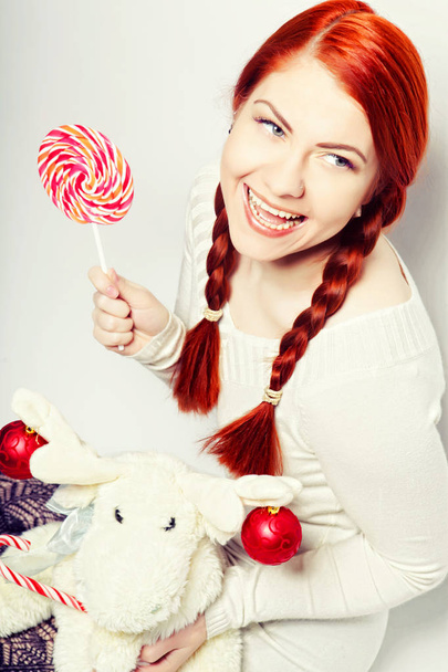 young redhair woman with deer toy.  - Zdjęcie, obraz