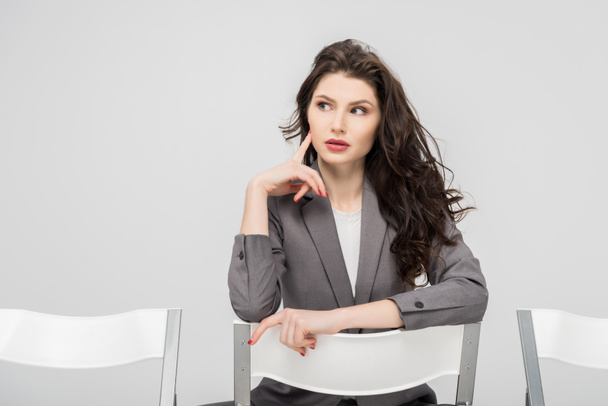pensive woman in formal wear thinking isolated on grey - Photo, image