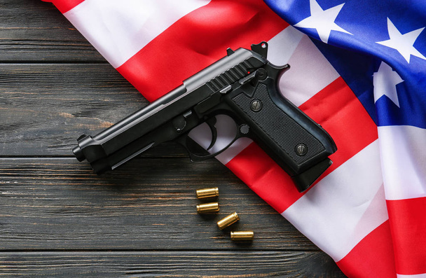 Pistol, bullets and USA flag on wooden background - Photo, Image