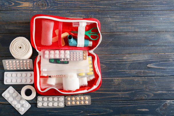 First aid kit on wooden background - Foto, imagen