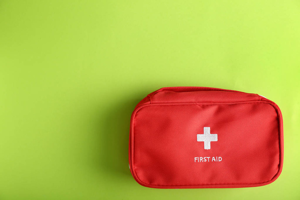 First aid kit on color background - Foto, Imagen