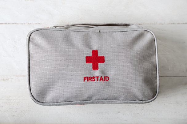 First aid kit on white table - Fotó, kép