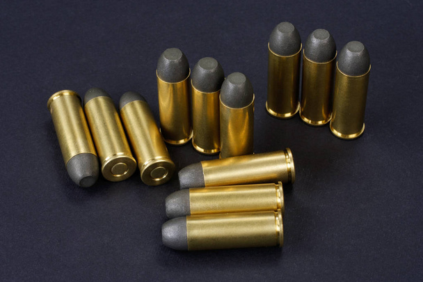 Black-powder revolver rounds .45 cal. dating to 1872 on black background - Foto, Imagen