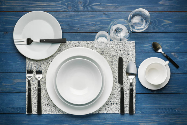 Simple table setting on color wooden background - Foto, imagen