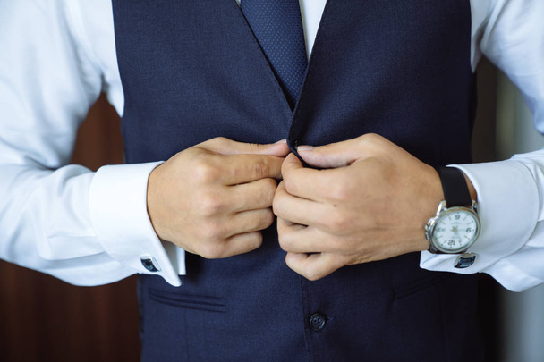 Close-up businessman groom wearing his jacket. Concept of men stylish elegance clothes - Photo, Image