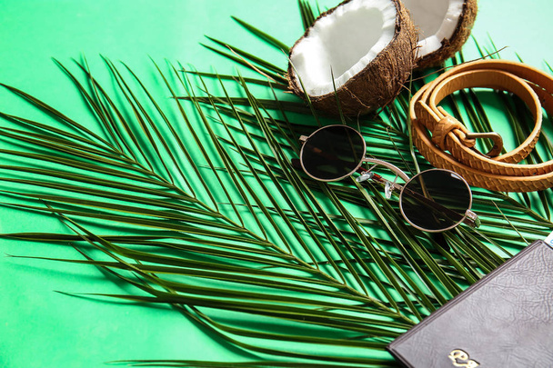 Composition with sunglasses and tropical leaf on color background - Фото, зображення