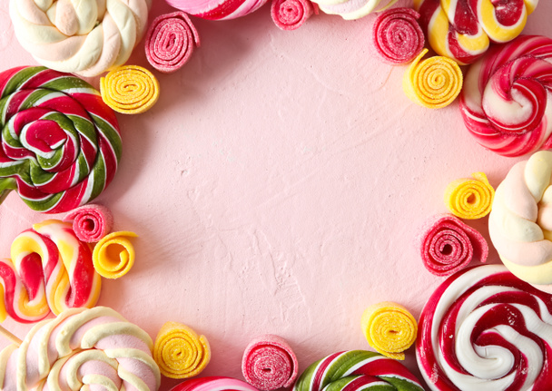 Frame made of different sweets on color background - Photo, Image