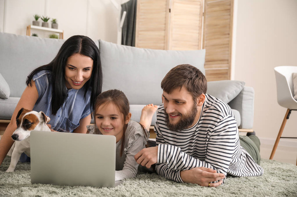 χαρούμενη οικογένεια που χρησιμοποιεί φορητό υπολογιστή στο σπίτι - Φωτογραφία, εικόνα
