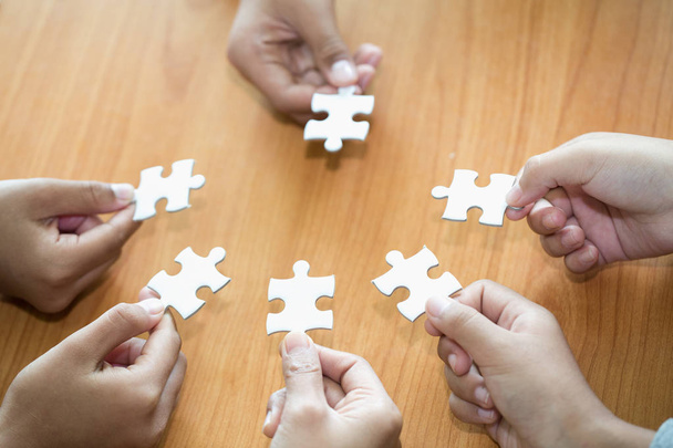 Many persons holding pieces of jigsaw puzzle,Teamwork concept,,Business connection,Success and strategy concept,Business accounting - Photo, Image