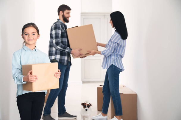 Family with cardboard boxes moving into new house - Photo, Image