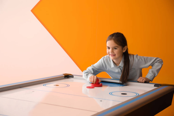Little girl playing air hockey indoors - Photo, Image