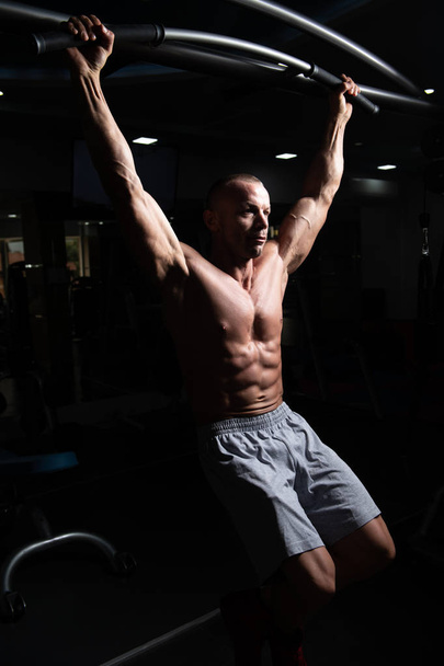 Male Athlete Doing Pull Ups - Chin-Ups In The Gym - Photo, image